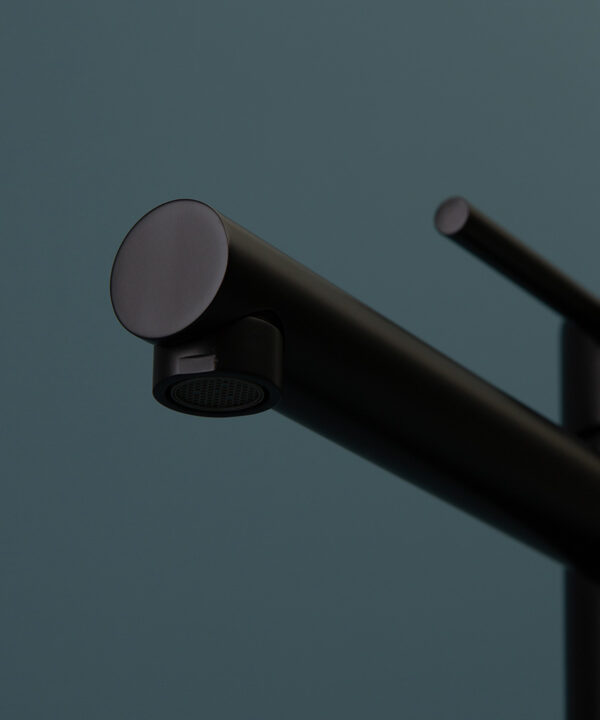 black inga tap close up of spout on blue background