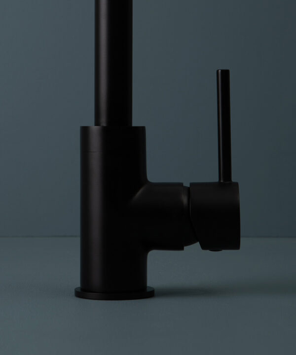 black kintampo tap close up of handle on blue background