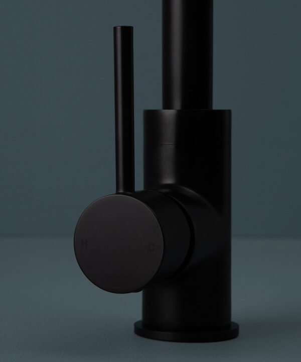 black kintampo tap close up of handle on blue background