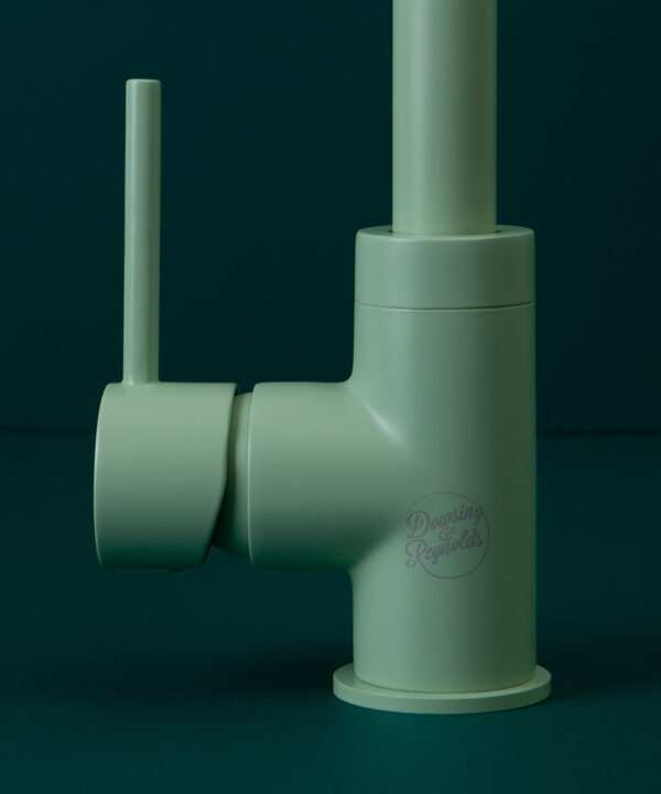 neo mint tinkisso tap close up of handle and logo on dark green background