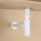 white bottle trap on peach background