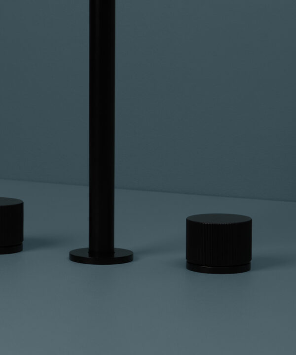 black reeded tap close up on blue background
