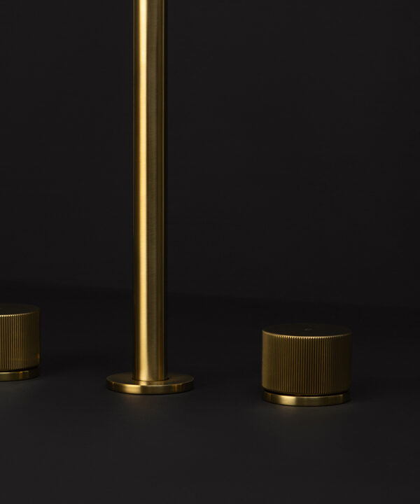 gold reeded tap close up gold reeded tap close up of spout on black background
