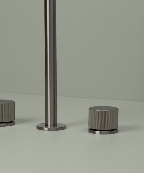 silver reeded tap close up on grey background