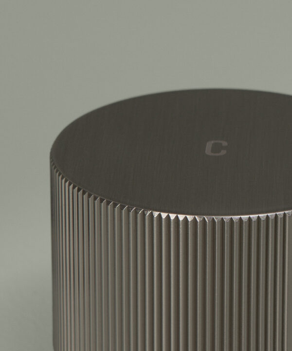 silver reeded tap close up of cold handle on grey background