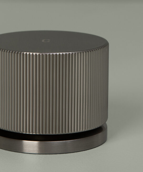 silver reeded tap closer up of handle on grey background