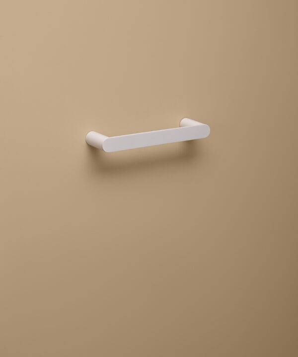 small white towel rail on peach background
