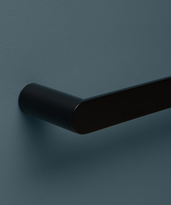 close up of black towel rail on blue background