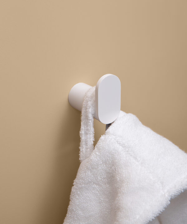 white robe hook on peach background