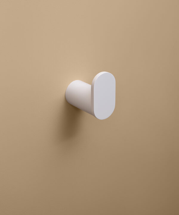white robe hook on peach background