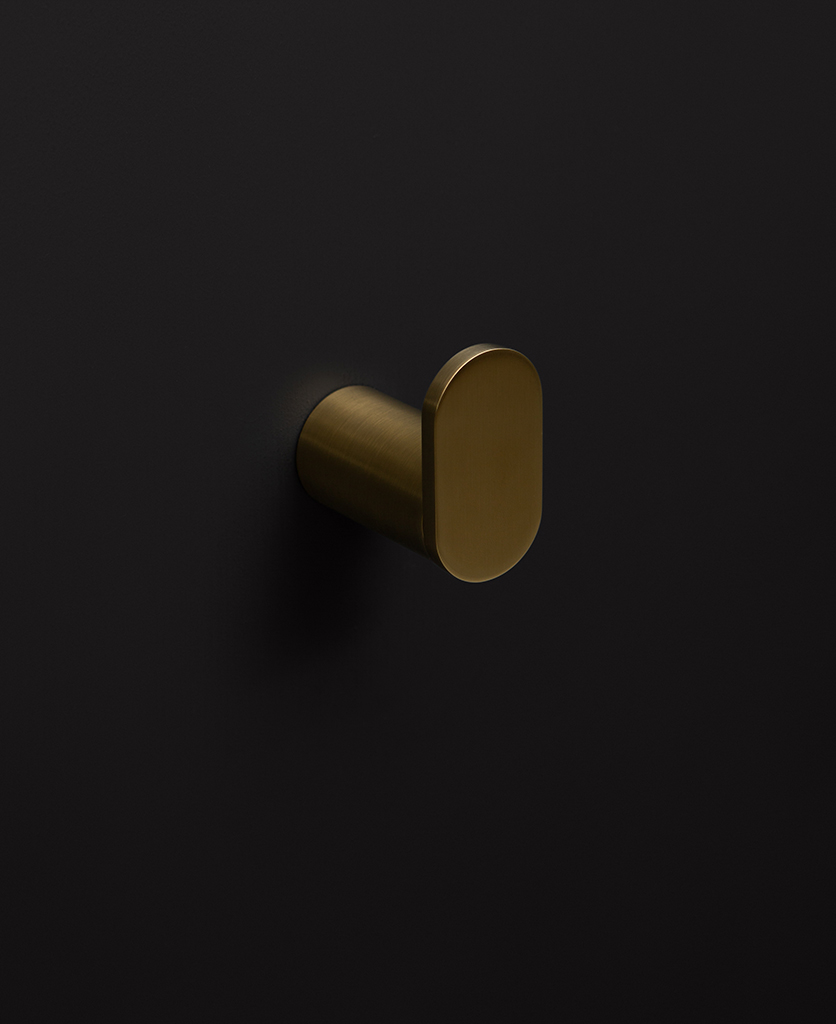 gold robe hook on black background