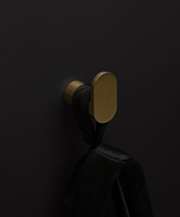 gold robe hook on black background