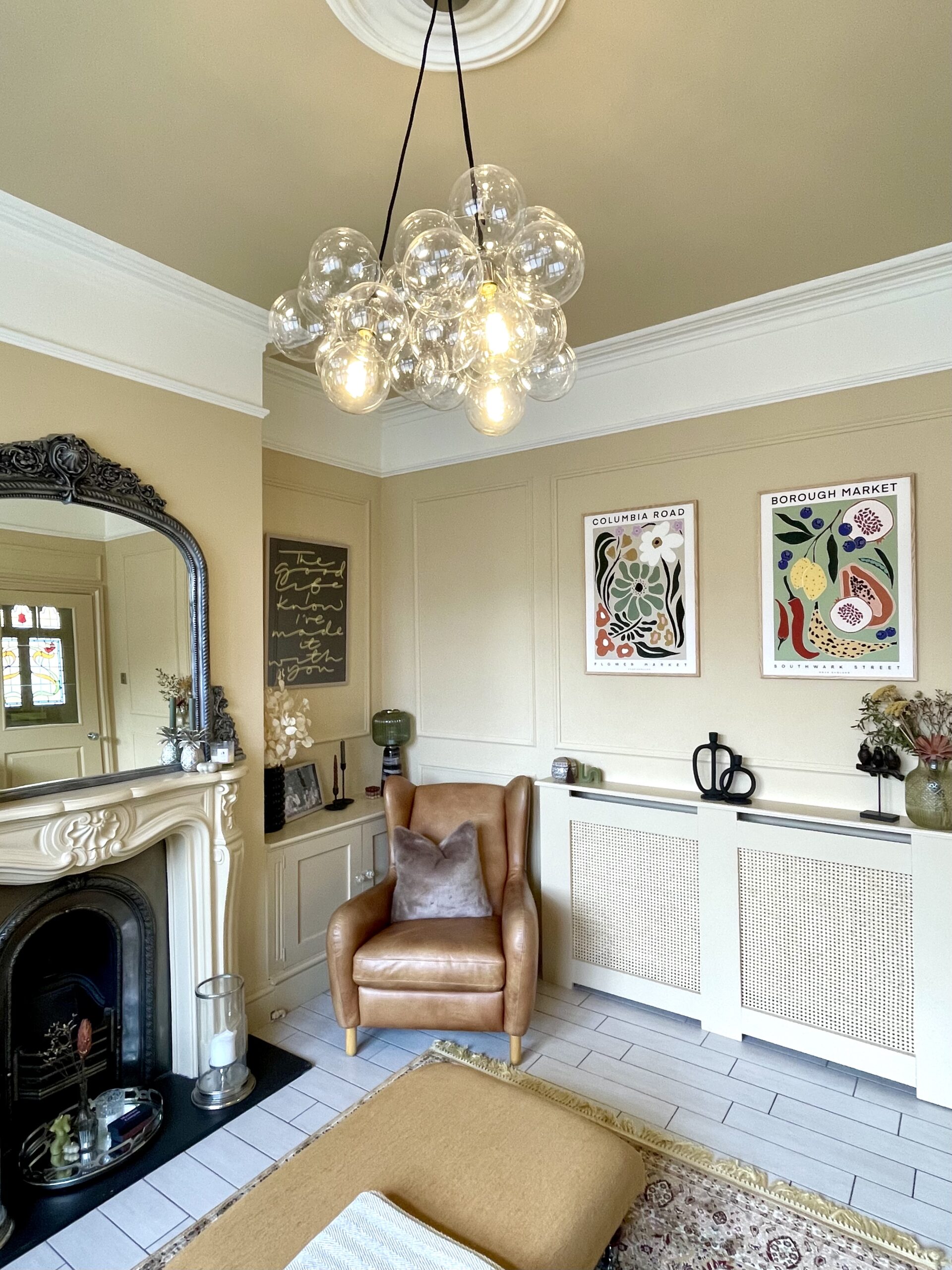 clear three point bubble chandlier in living room of Victorian home