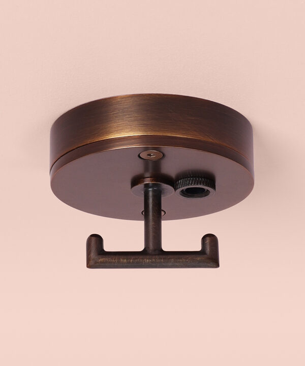 brewer's brass t-hook ceiling rose on pink background