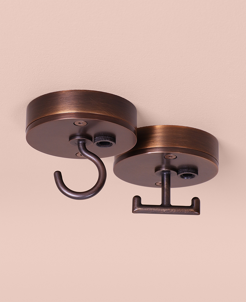 brewer's brass c-hook and t-hook ceiling roses on pink background