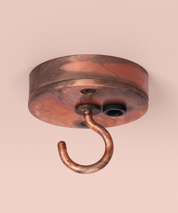 tarnished copper c-hook ceiling rose on pink background