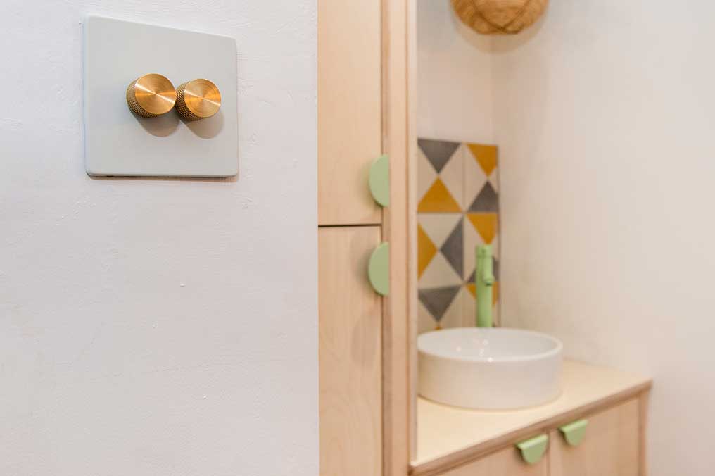 white and gold double dimmer, neo mint mezzaluna handles and neo mint inga tap in a white bathroom