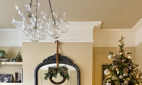 christmas tree in Victorian living room with clear bubble chandelier suspended from ceiling