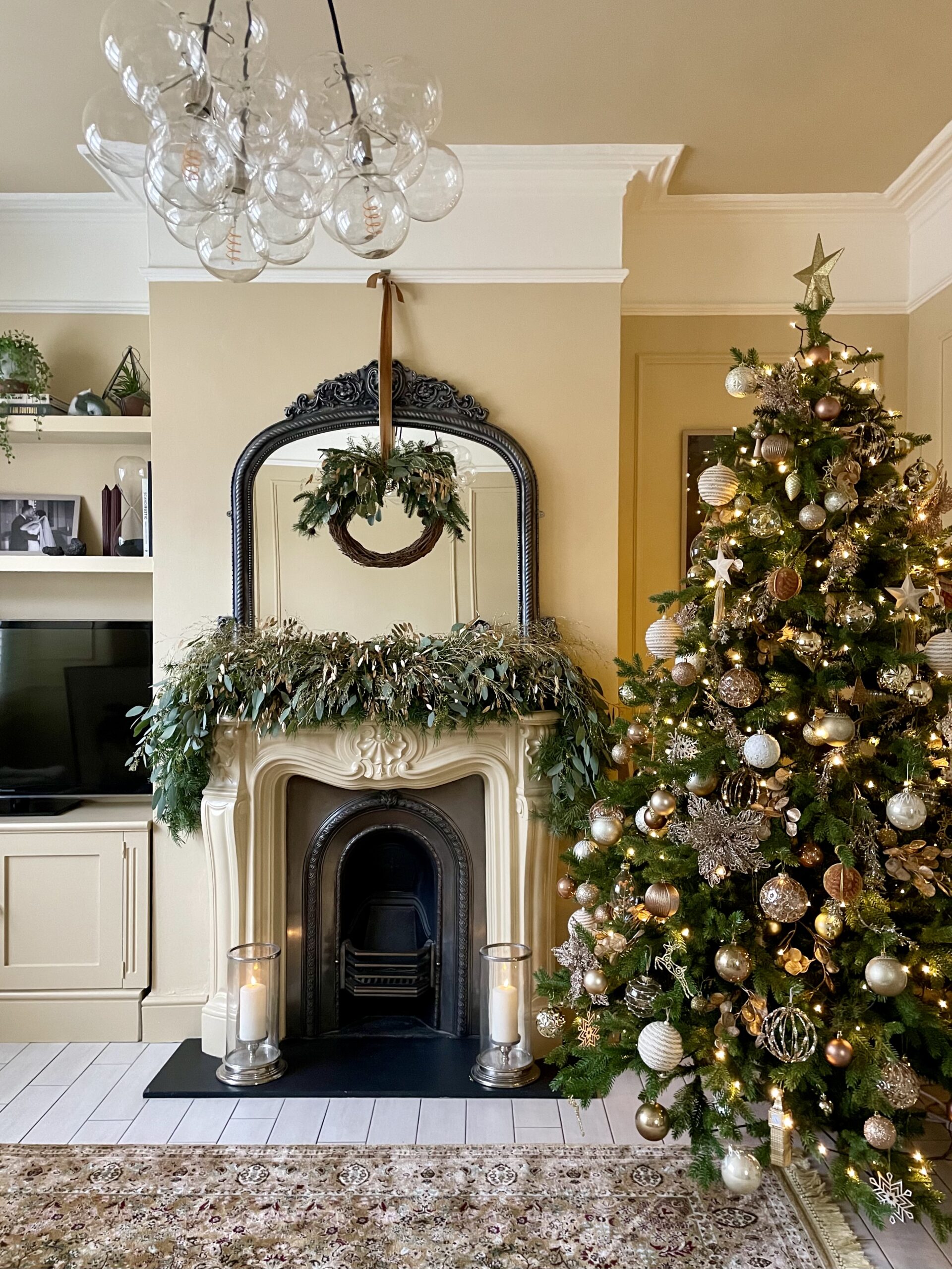 christmas tree in Victorian living room with clear bubble chandelier suspended from ceiling