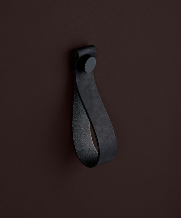 large black magni handle with black stud against chocolate brown background