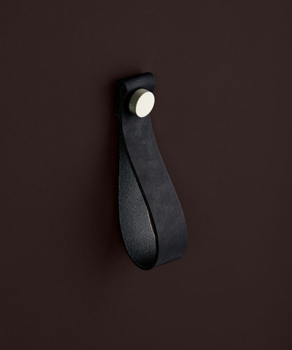 large black magni handle with silver stud against chocolate brown background