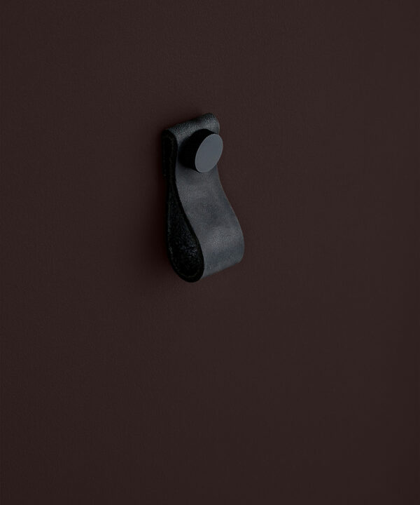 small black magni handle with black stud against chocolate brown background