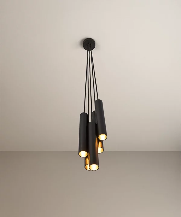 black baton cluster pendant light with five lights, fabric cable and black ceiling rose hanging in a neutral room
