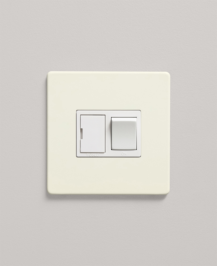 whipped cream fused spur switch on a neutral kitchen wall