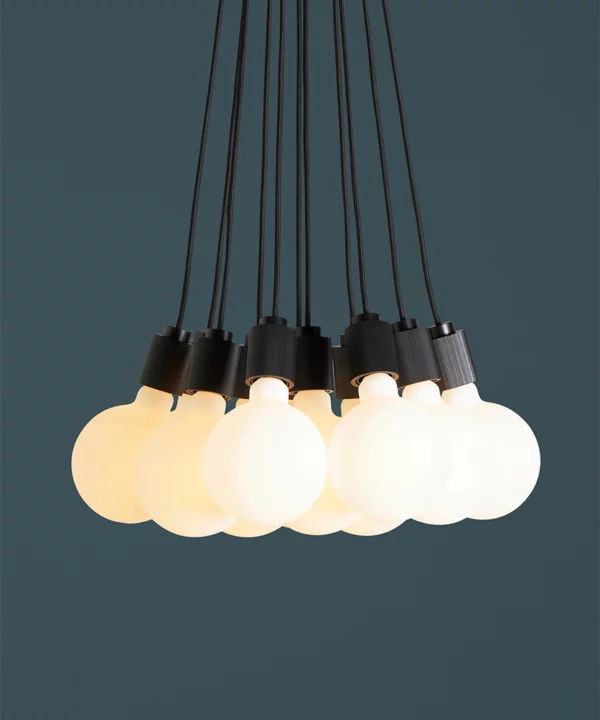 closeup of black athenee statement pendant light against blue background