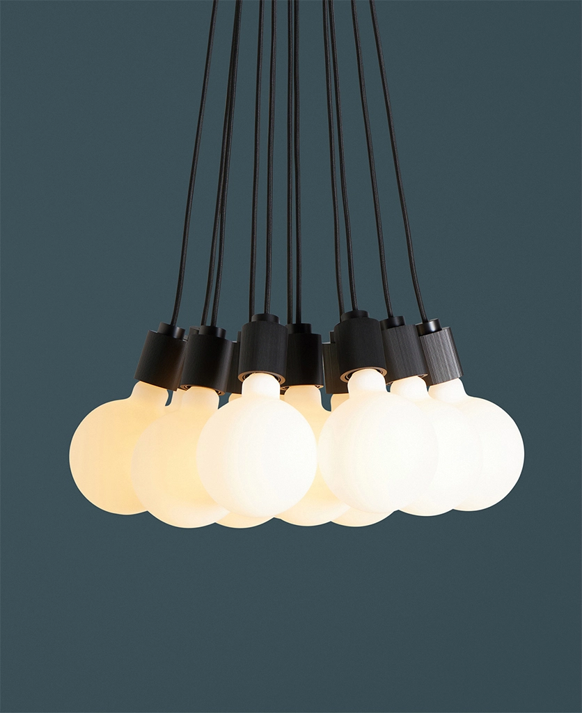 closeup of black athenee statement pendant light against blue background