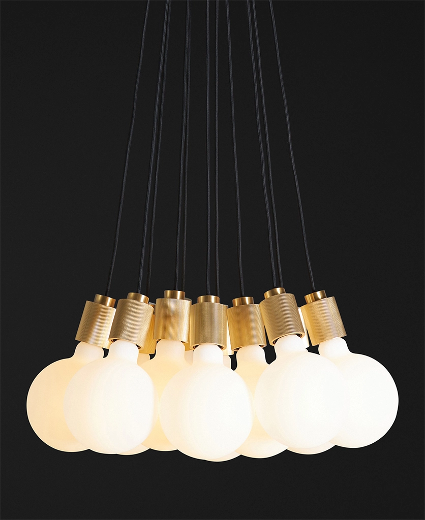 front shot of gold athenee statement pendant light against black background