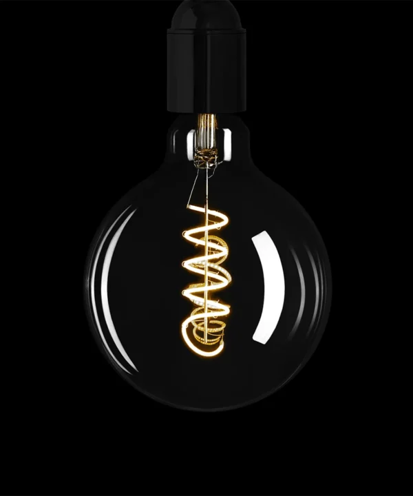 smoked light bulb with spiral filament against black background