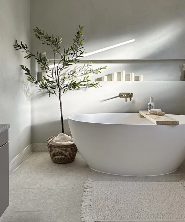 Faux olive tree in a bathroom.
