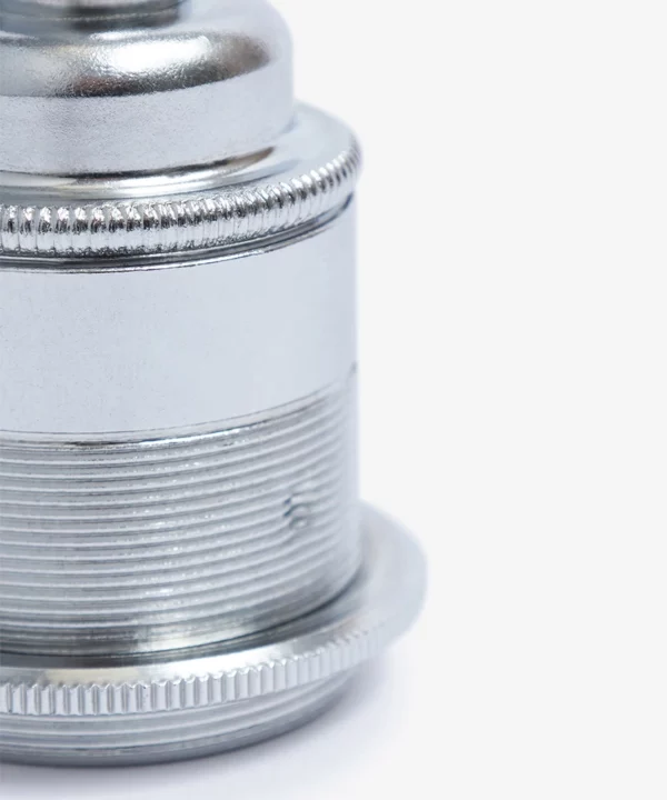 closeup of chrome bulb holder against white background
