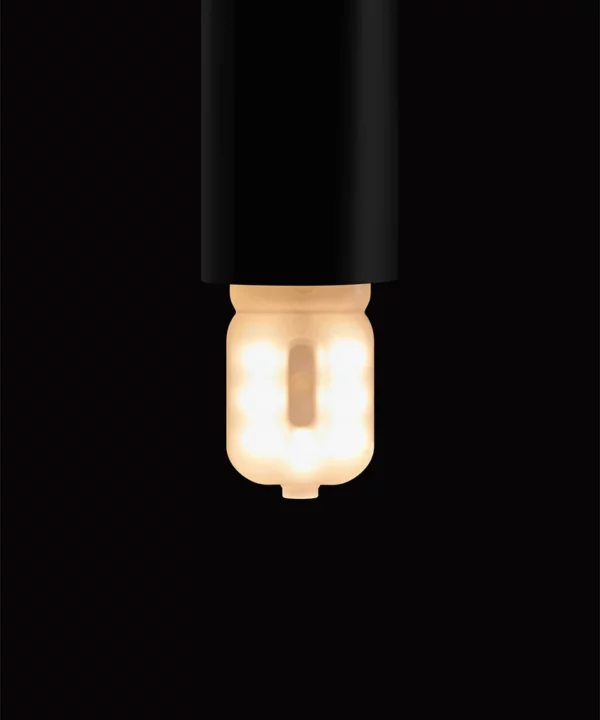 G9 LED bulb in a black bulb holder against a black background