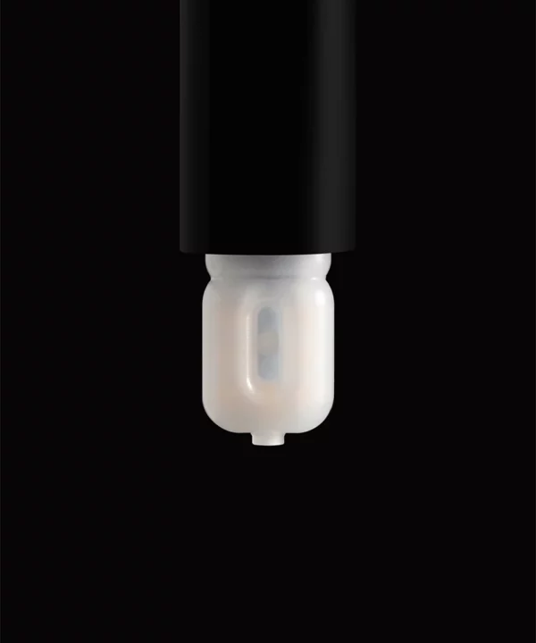 unlit G9 LED bulb in a black bulb holder against a black background