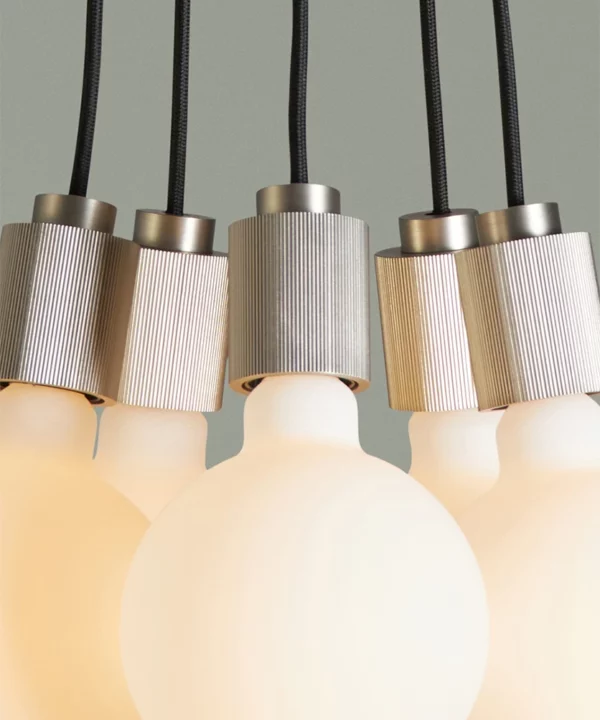 closeup of silver meurice dining table light against green background