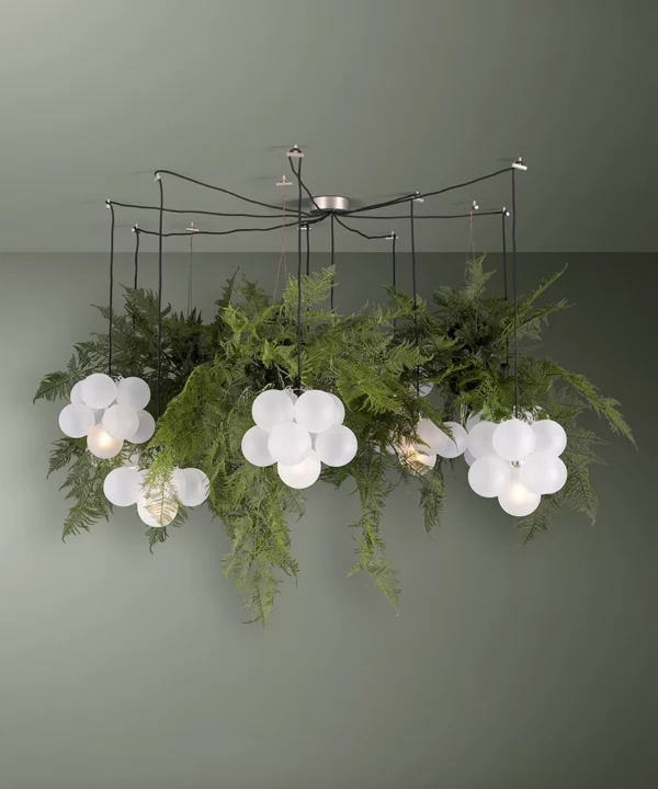 fern light bubble chandelier - frosted bulbs nestled amongst faux ferns light installation