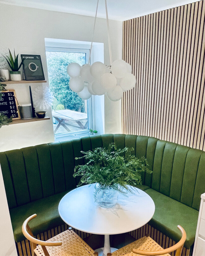 frosted bubble chandelier suspended over cosy dining nook in a kitchen