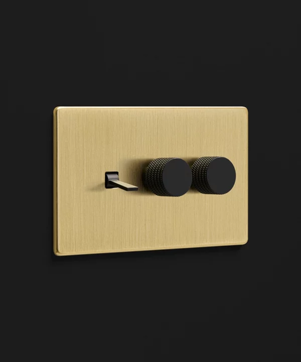 brushed brass gold plate combination switch with one tapered toggle light switch and two knurled dimmers in black