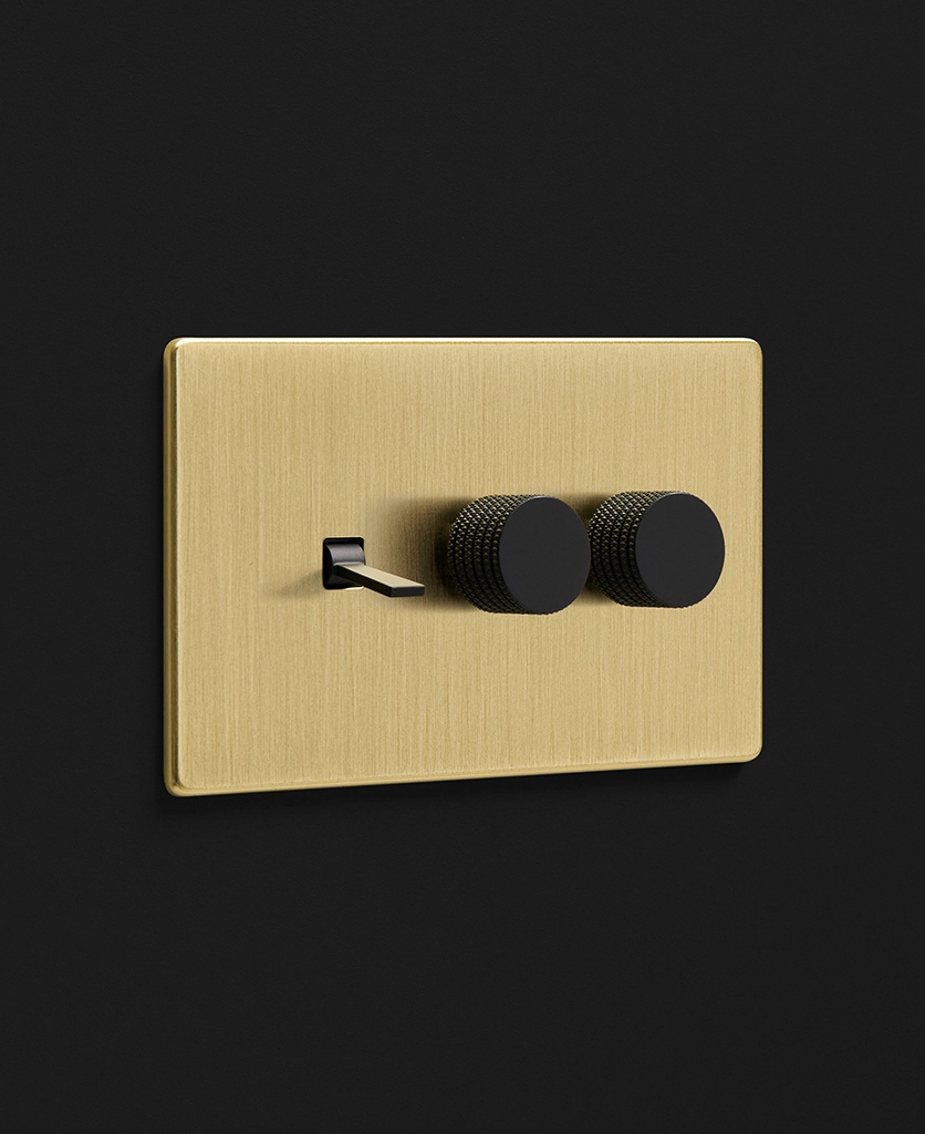 brushed brass gold plate combination switch with one tapered toggle light switch and two knurled dimmers in black