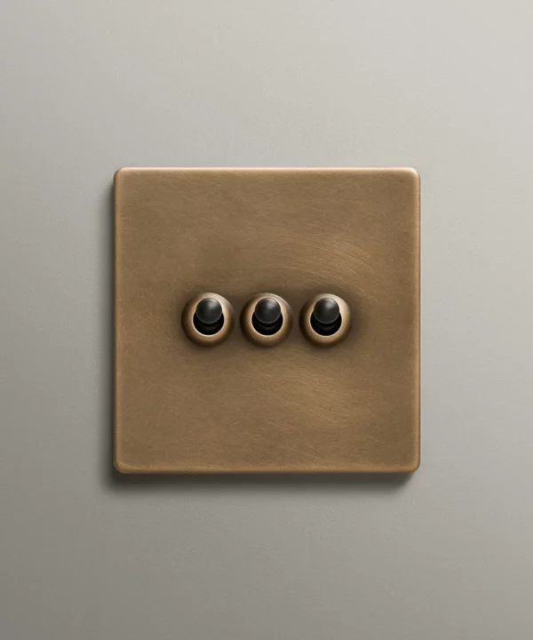 antique brass toggle switch with three black toggles