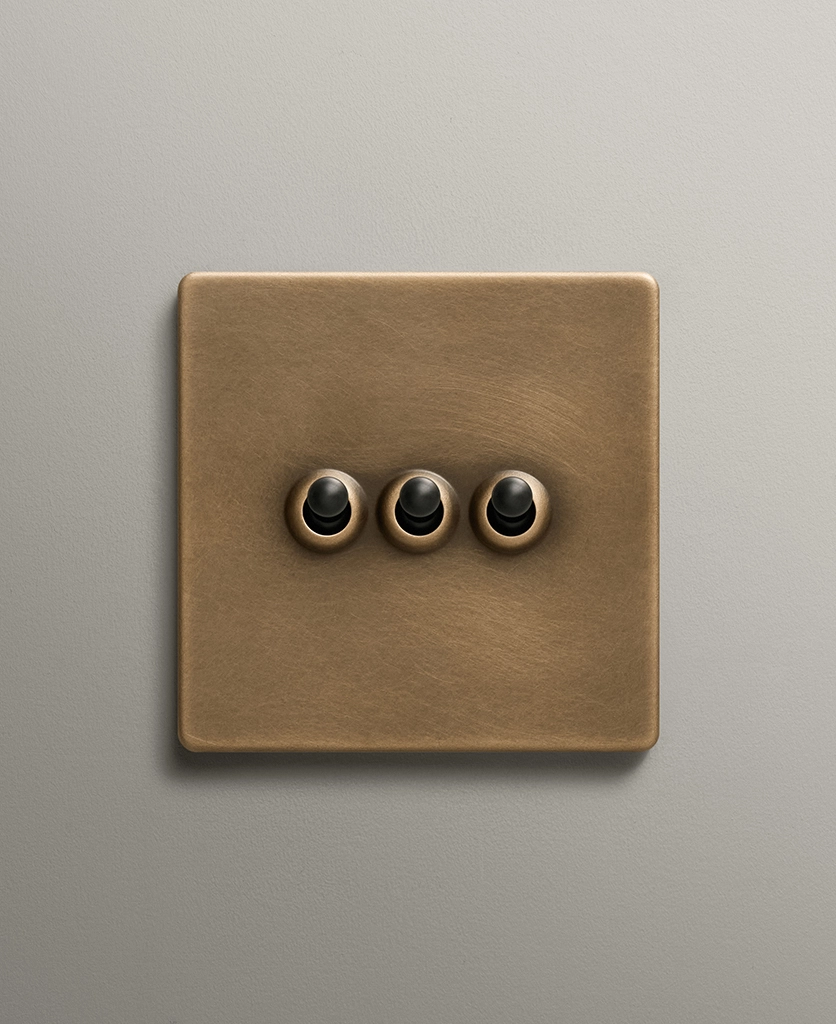 antique brass toggle switch with three black toggles