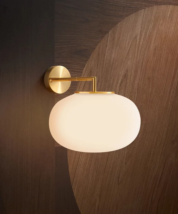 gold wall light with opaque glass shade