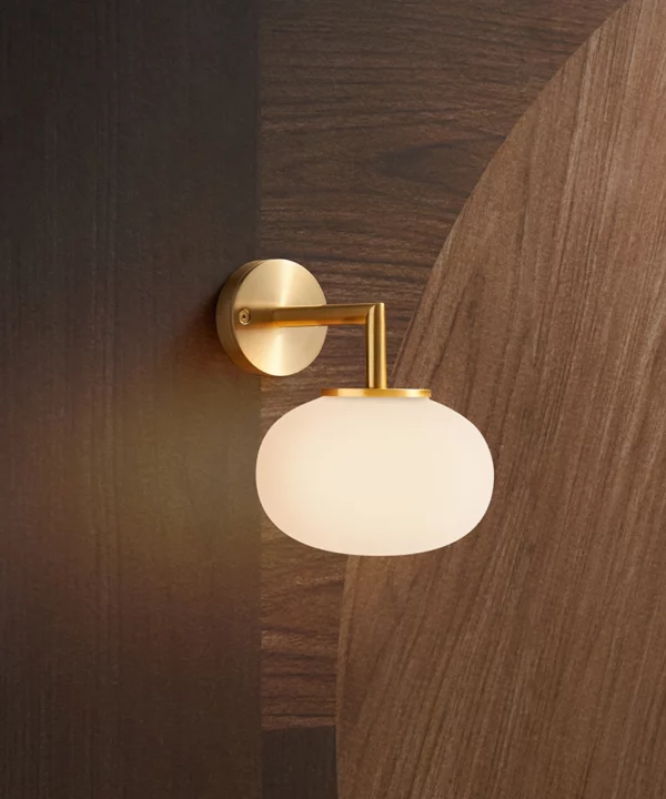 modern wall light with gold metal hardware and frosted glass shade