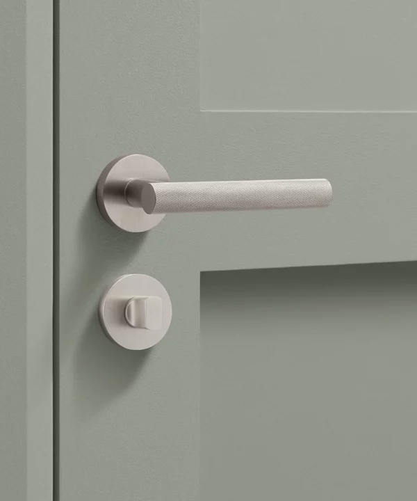 silver Hirst handle on sage green internal door with thumblock