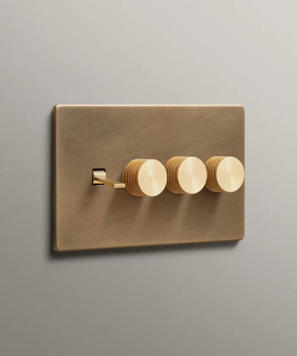 antique brass quadruple 4 gang combination switch with 1 tapered toggle and three knurled dimmer knobs in gold