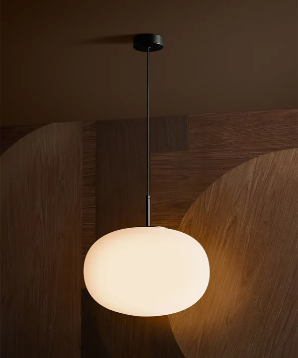 black pendant light in art deco style with large round opaque glass shade
