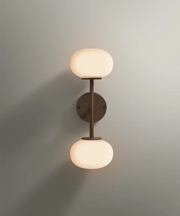 wall light shown with two opaque glass bulbs