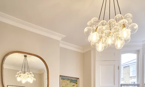 bubble chandelier lit with warm bulbs in a living room